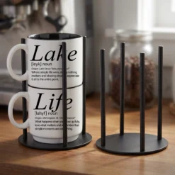Our black metal Storyteller Display Stands hold a stack of 14-ounce Coffee & Words mugs and fit neatly on any counter or coffee bar.