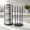 Our black metal Storyteller Display Stands hold a stack of 14-ounce Coffee & Words mugs and fit neatly on any counter or coffee bar.