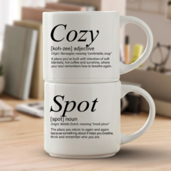 Cozy + Spot mug set in Timeless Italic font, two 14-ounce white stackable mugs with white interiors and Meaningful Word Story Style definitions on a writer’s desk