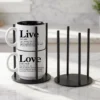 Our black metal Storyteller Display Stands hold a stack of 14-ounce Coffee & Words mugs and fit neatly on any counter or coffee bar.