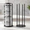 Our black metal Storyteller Display Stands hold a stack of 14-ounce Coffee & Words mugs and fit neatly on any counter or coffee bar.