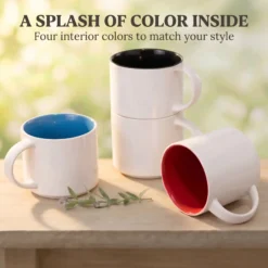 Four blank 14-ounce stackable ceramic mugs with glossy white exteriors and Ocean Blue, Black and Red interiors on a wooden table.